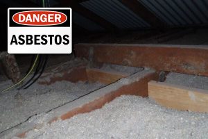 Asbestos loose fill in ceiling with danger sign