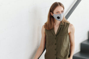 Woman wears mask in stairwell