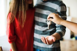 Keys being handed to couple
